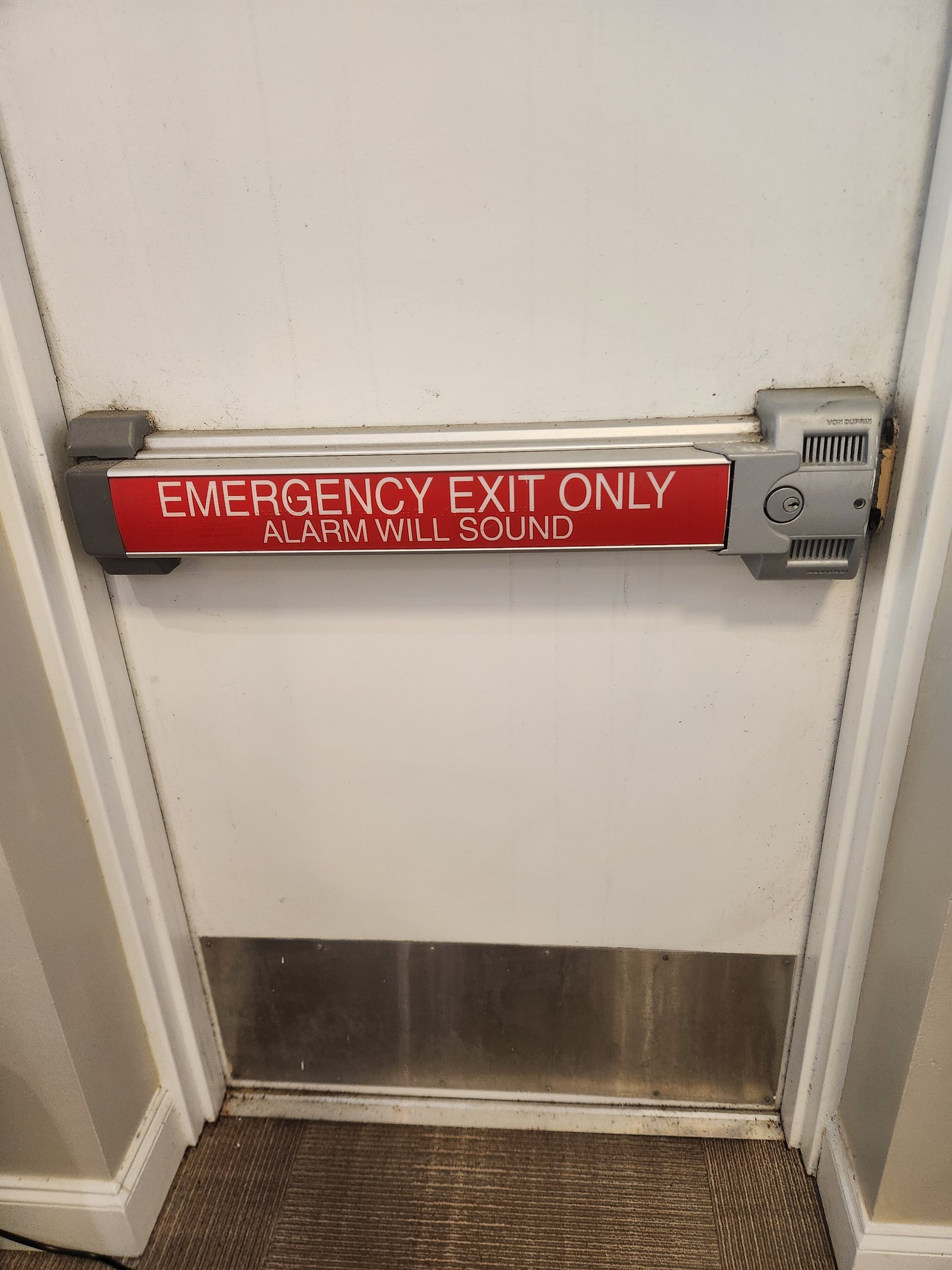 Emergency exit door with panic bar hardware