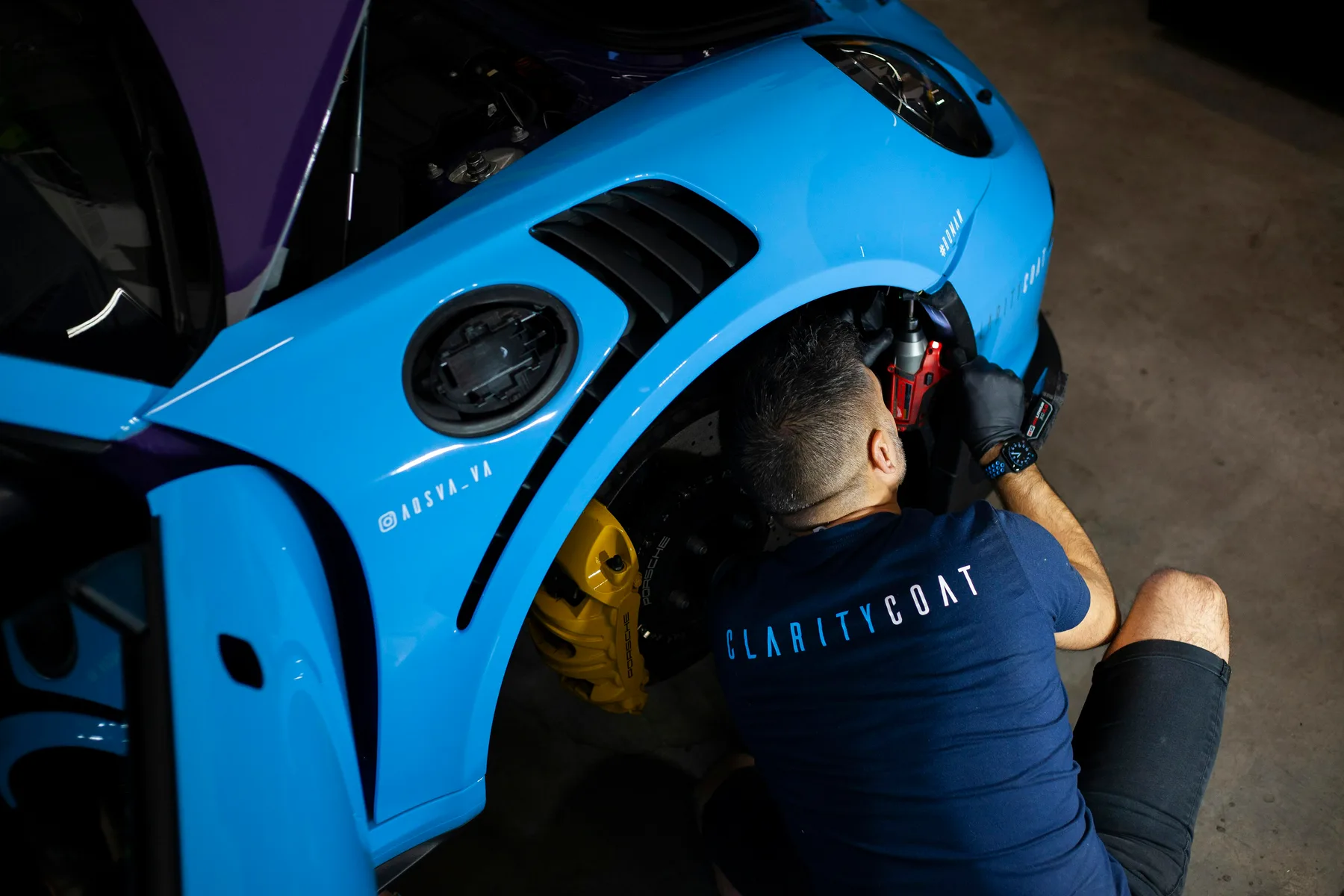 Mobile automotive locksmith programming a new smart key fob and repairing a car door lock